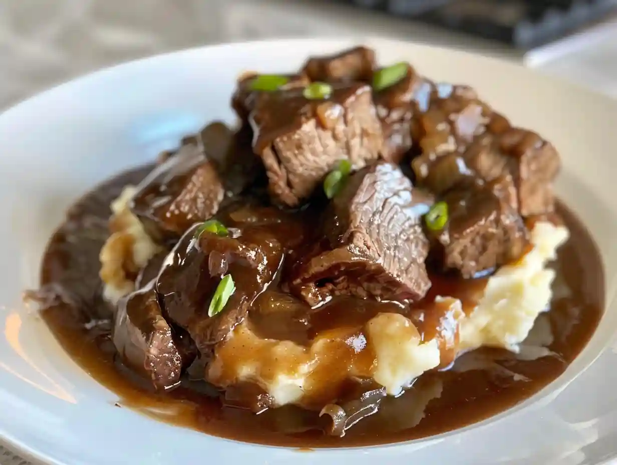Beef tips and gravy recipe served with mashed potatoes